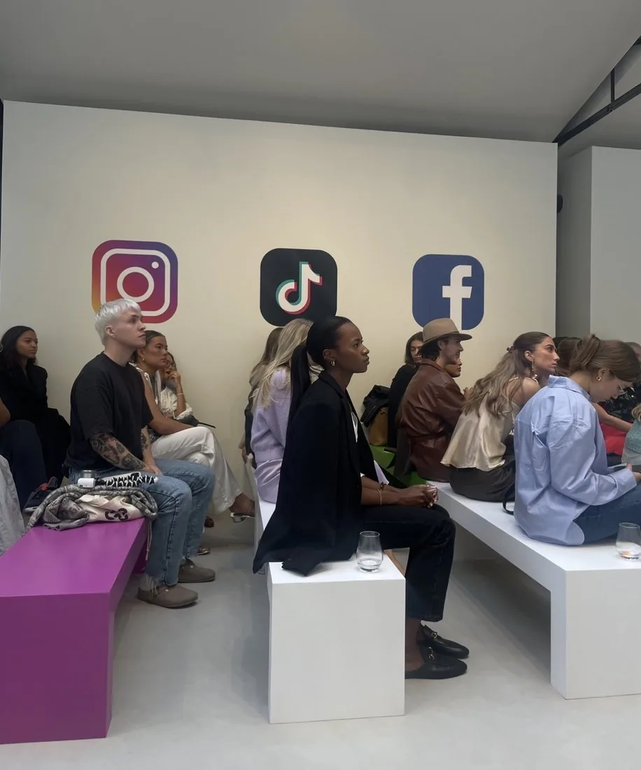 An audience of creators and marketers at an event, with the Instagram, TikTok and Facebook logos on the wall